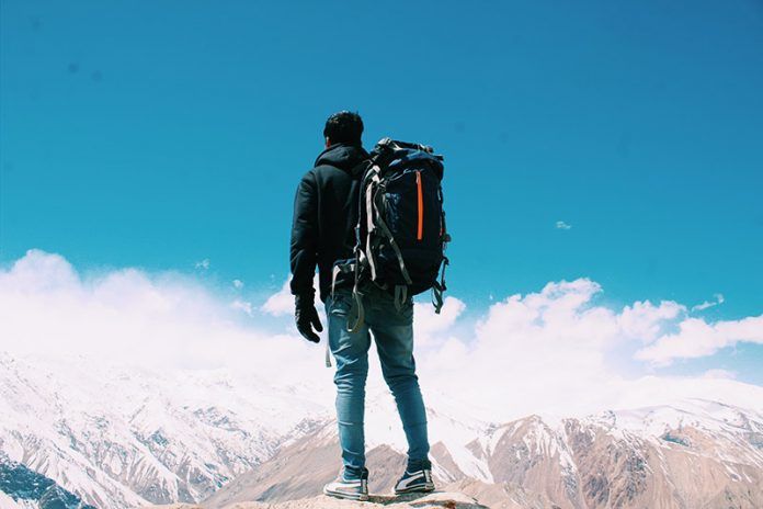 photo-of-man-standing-on-top-of-mountain-2577274
